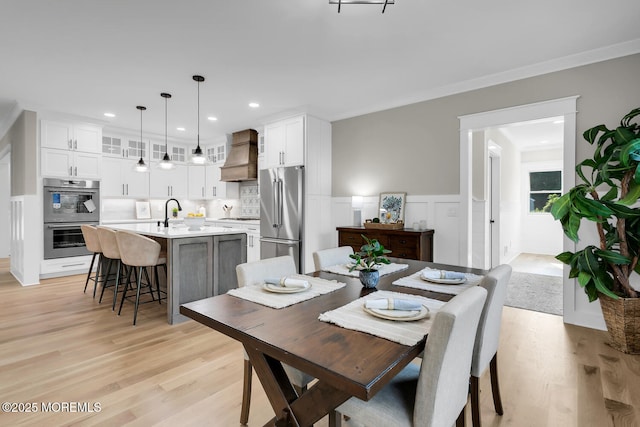 515 Atlantic Ave, Middletown, NJ 07748 - dining room with light wood-style floors, wainscoting, ornamental molding, a decorative wall, and recessed lighting