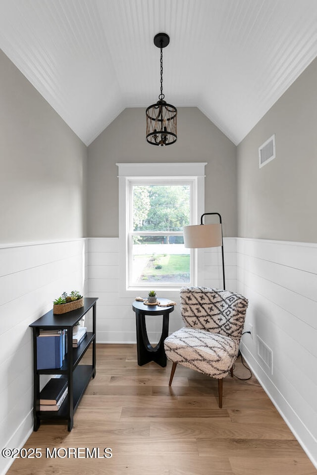 515 Atlantic Ave, Middletown, NJ 07748 - living area with wainscoting, lofted ceiling, light wood-type flooring, and a chandelier