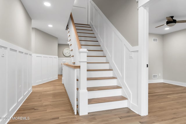 515 Atlantic Ave, Middletown, NJ 07748 - staircase featuring wood finished floors, a ceiling fan, a decorative wall, a wainscoted wall, and recessed lighting