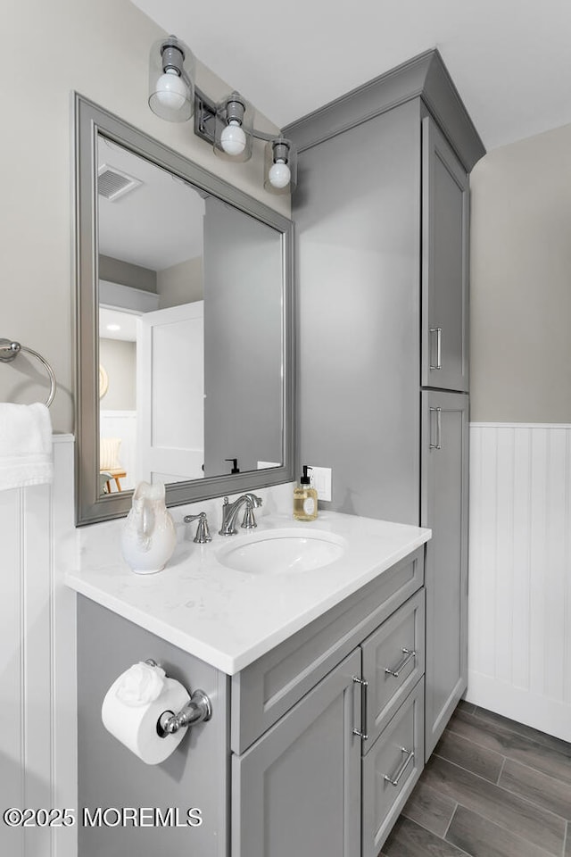 515 Atlantic Ave, Middletown, NJ 07748 - bathroom with vanity, wainscoting, and wood finished floors