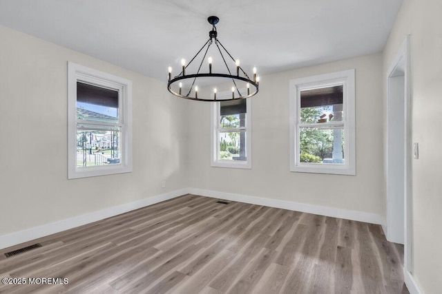 420 Philadelphia Ave, Egg Harbor City, NJ 08215 - unfurnished dining area with a chandelier, plenty of natural light, and wood finished floors