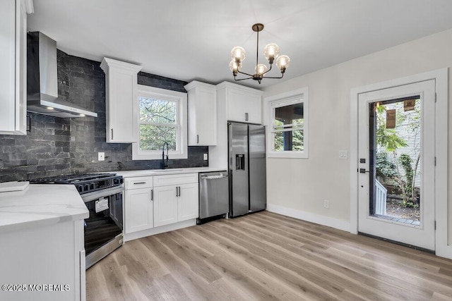 420 Philadelphia Ave, Egg Harbor City, NJ 08215 - kitchen with appliances with stainless steel finishes, wall chimney exhaust hood, tasteful backsplash, light wood-style floors, and plenty of natural light