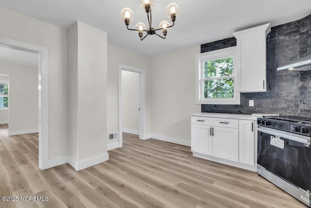 420 Philadelphia Ave, Egg Harbor City, NJ 08215 - kitchen featuring stainless steel range with gas stovetop, a chandelier, tasteful backsplash, and healthy amount of natural light