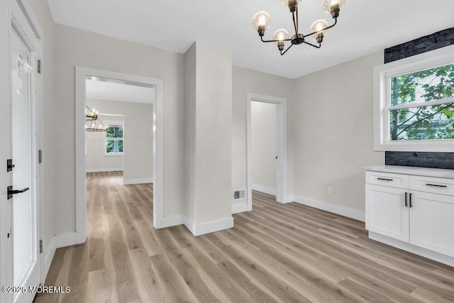 420 Philadelphia Ave, Egg Harbor City, NJ 08215 - unfurnished dining area with a chandelier and light wood-type flooring