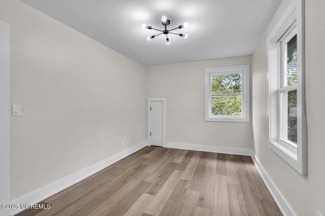 420 Philadelphia Ave, Egg Harbor City, NJ 08215 - empty room featuring light wood-style flooring and a chandelier
