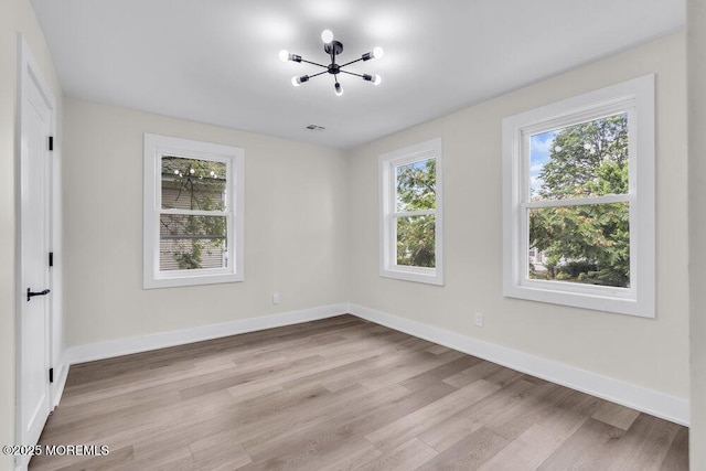 420 Philadelphia Ave, Egg Harbor City, NJ 08215 - unfurnished bedroom with a chandelier and light wood finished floors