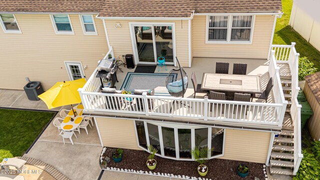 36 Cori St, Parlin, NJ 08859 - rear view of house featuring a shingled roof, stairway, a wooden deck, and a patio