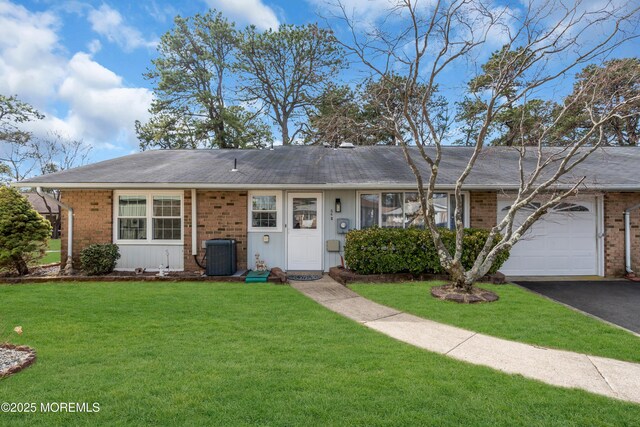 66B Buckingham Dr, Manchester, NJ 08759 - ranch-style home with brick siding, a front yard, and a garage