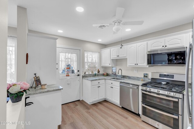 66B Buckingham Dr, Manchester, NJ 08759 - kitchen featuring appliances with stainless steel finishes, ceiling fan, white cabinets, light wood-style floors, and light stone countertops