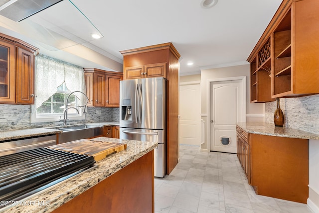 26 N Boston Rd, Jackson, NJ 08527 - kitchen with appliances with stainless steel finishes, crown molding, brown cabinets, light stone countertops, and washer / dryer