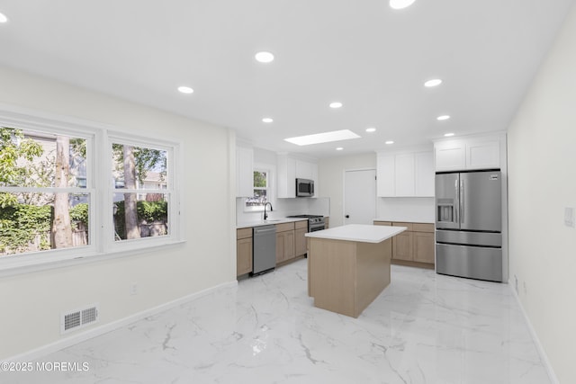 74 Brand Rd, Toms River, NJ 08753 - kitchen with appliances with stainless steel finishes, light marble finish floors, a center island, recessed lighting, and light countertops