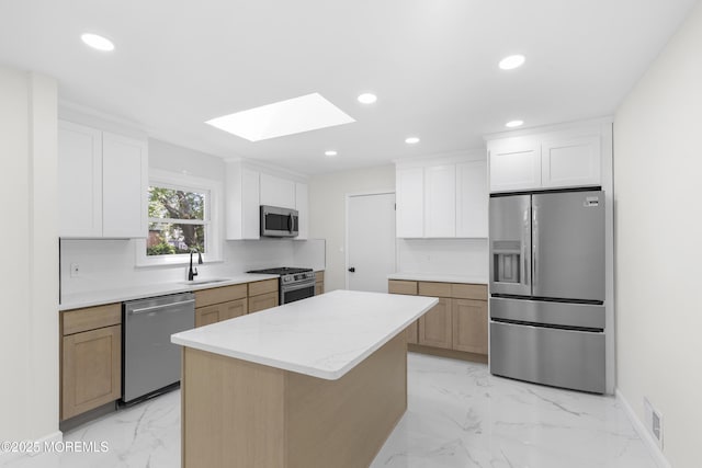 74 Brand Rd, Toms River, NJ 08753 - kitchen with appliances with stainless steel finishes, a skylight, light marble finish flooring, a center island, and recessed lighting