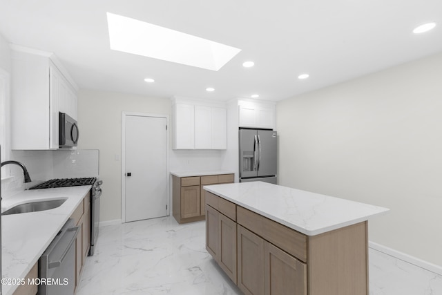 74 Brand Rd, Toms River, NJ 08753 - kitchen featuring stainless steel appliances, a skylight, light marble finish floors, recessed lighting, and a kitchen island
