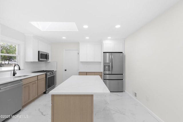 74 Brand Rd, Toms River, NJ 08753 - kitchen featuring stainless steel appliances, a skylight, light marble finish floors, a center island, and recessed lighting