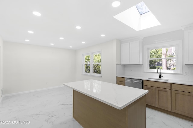 74 Brand Rd, Toms River, NJ 08753 - kitchen featuring dishwasher, a kitchen island, recessed lighting, a skylight, and light marble finish flooring