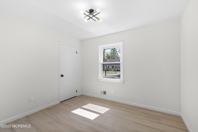74 Brand Rd, Toms River, NJ 08753 - spare room with light wood-style flooring and a chandelier