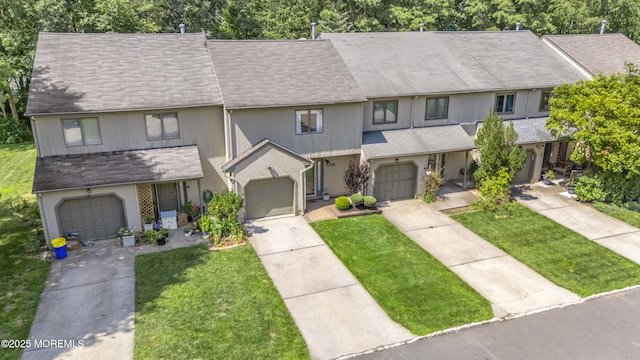 48 Carmel Ct, Old Bridge, NJ 08857 - townhome / multi-family property with a front lawn, driveway, a shingled roof, and a garage