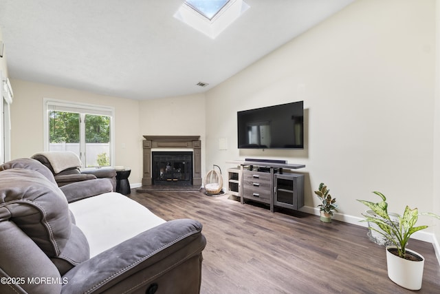 48 Carmel Ct, Old Bridge, NJ 08857 - living room featuring wood finished floors, a skylight, and a glass covered fireplace