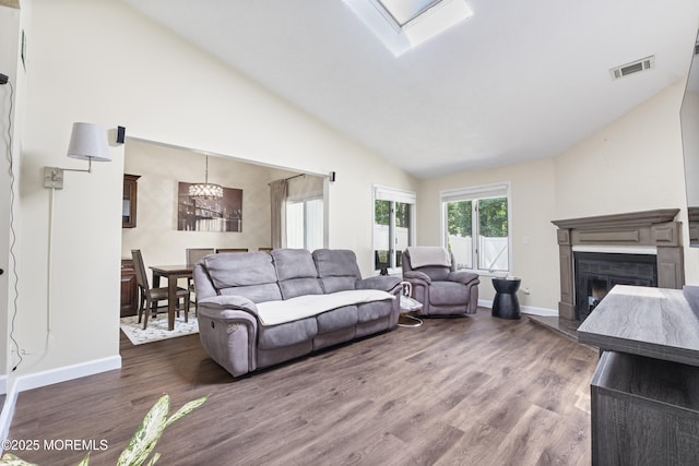 48 Carmel Ct, Old Bridge, NJ 08857 - living area featuring a glass covered fireplace, wood finished floors, a chandelier, and high vaulted ceiling