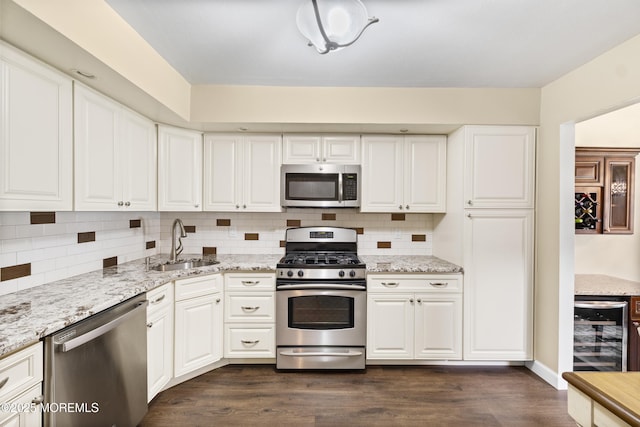 48 Carmel Ct, Old Bridge, NJ 08857 - kitchen featuring stainless steel appliances, decorative backsplash, dark wood-style flooring, beverage cooler, and white cabinetry