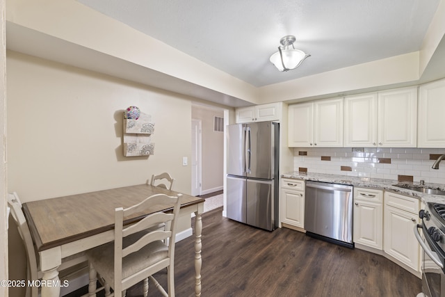 48 Carmel Ct, Old Bridge, NJ 08857 - kitchen with stainless steel appliances, dark wood-type flooring, backsplash, light stone counters, and white cabinets
