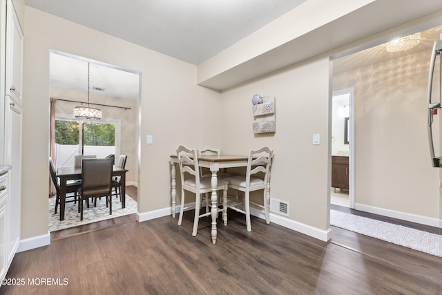 48 Carmel Ct, Old Bridge, NJ 08857 - dining area with a chandelier and dark wood-style flooring