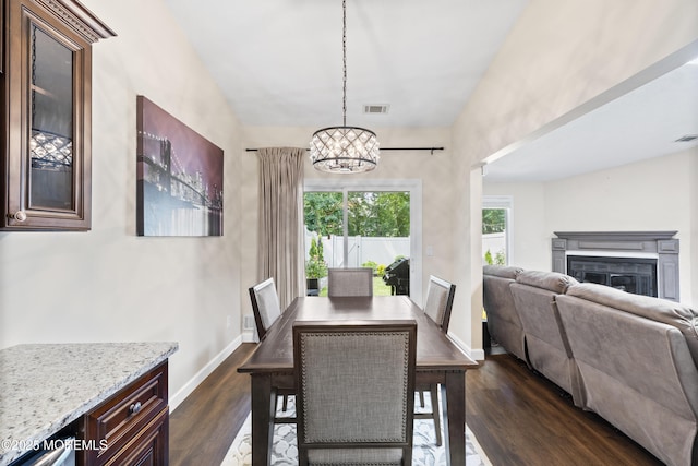 48 Carmel Ct, Old Bridge, NJ 08857 - dining room featuring a chandelier, dark wood-style flooring, a glass covered fireplace, and lofted ceiling