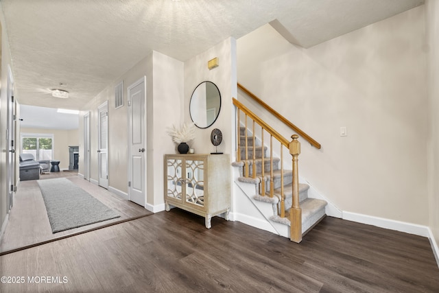48 Carmel Ct, Old Bridge, NJ 08857 - foyer with wood finished floors, stairs, and a fireplace