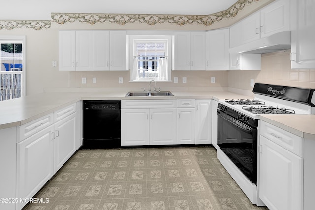 305 11th Ave, Spring Lake Heights, NJ 07762 - kitchen with black dishwasher, range with gas cooktop, under cabinet range hood, a peninsula, and decorative backsplash