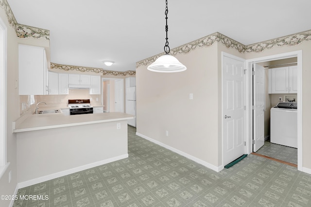 305 11th Ave, Spring Lake Heights, NJ 07762 - kitchen featuring washer / dryer, white appliances, light flooring, light countertops, and hanging light fixtures