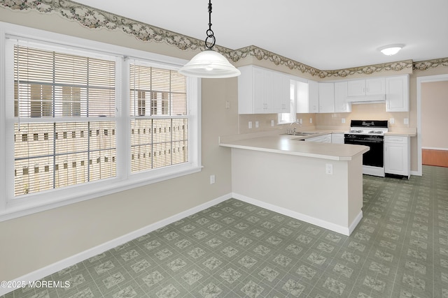 305 11th Ave, Spring Lake Heights, NJ 07762 - kitchen featuring white range with gas cooktop, light countertops, a peninsula, and tile patterned floors