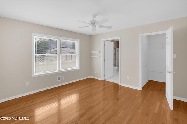 305 11th Ave, Spring Lake Heights, NJ 07762 - unfurnished bedroom featuring a walk in closet, light wood-style flooring, a closet, ensuite bathroom, and a ceiling fan