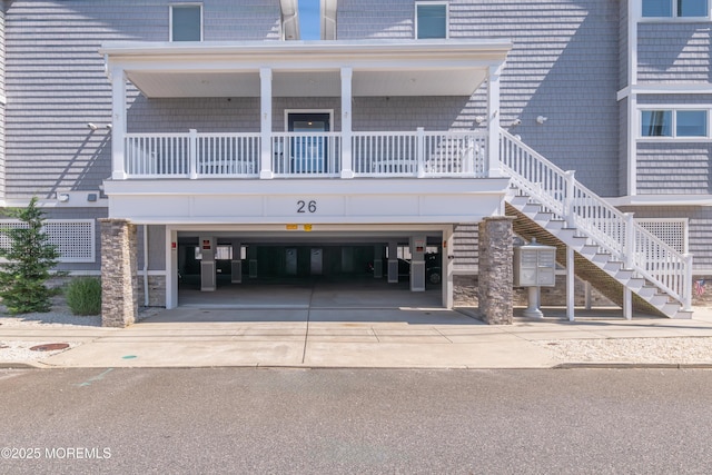 26 9th Ave Unit 105, Ortley Beach, NJ 08751 - view of building exterior featuring stairs and concrete driveway