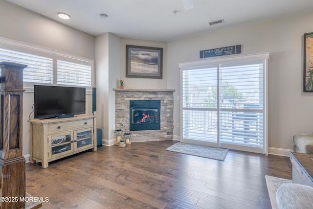 26 9th Ave Unit 105, Ortley Beach, NJ 08751 - living area featuring plenty of natural light, wood finished floors, and a stone fireplace
