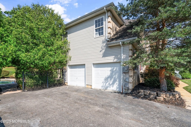 2 Muirwood Ct, Jackson, NJ 08527 - view of side of home featuring a garage and asphalt driveway