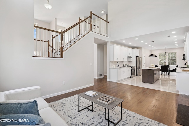 2 Muirwood Ct, Jackson, NJ 08527 - living room with light wood-style flooring, a towering ceiling, and recessed lighting