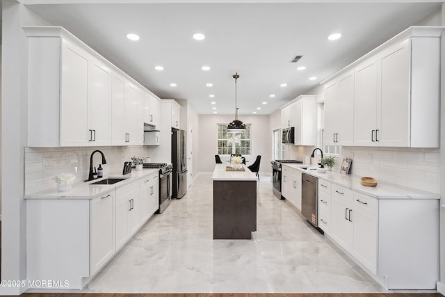 2 Muirwood Ct, Jackson, NJ 08527 - kitchen with stainless steel appliances, a center island, light marble finish floors, recessed lighting, and decorative backsplash