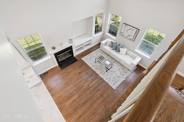 2 Muirwood Ct, Jackson, NJ 08527 - living room featuring a high ceiling, plenty of natural light, wood finished floors, and a fireplace with flush hearth