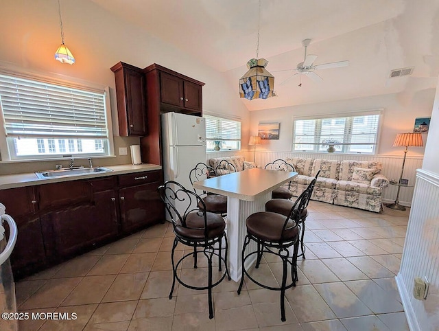 215 Harbor Dr, Lavallette, NJ 08735 - dining space with wainscoting, high vaulted ceiling, ceiling fan, healthy amount of natural light, and light tile patterned floors