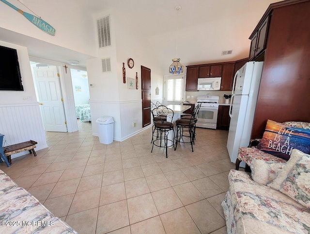 215 Harbor Dr, Lavallette, NJ 08735 - dining space featuring a wainscoted wall, light tile patterned flooring, and high vaulted ceiling