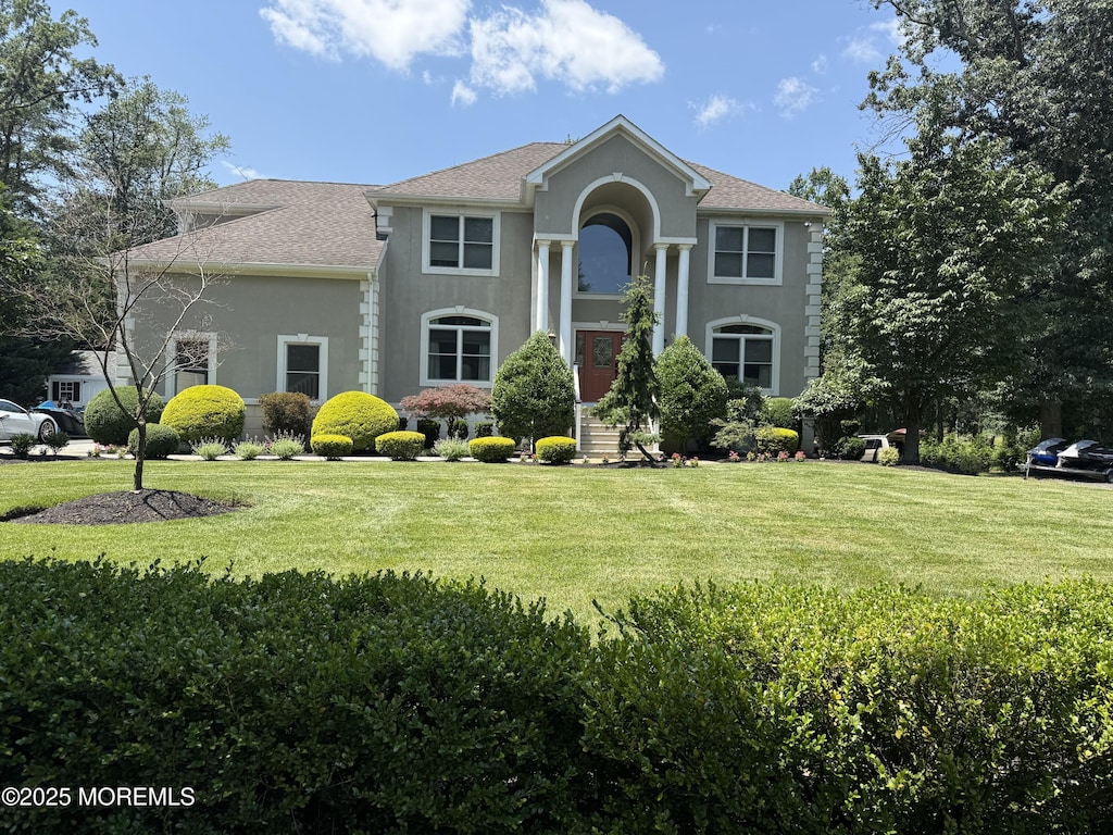 284 Friendship Rd, Howell, NJ 07731 - view of front facade featuring stucco siding, a front yard, and roof with shingles
