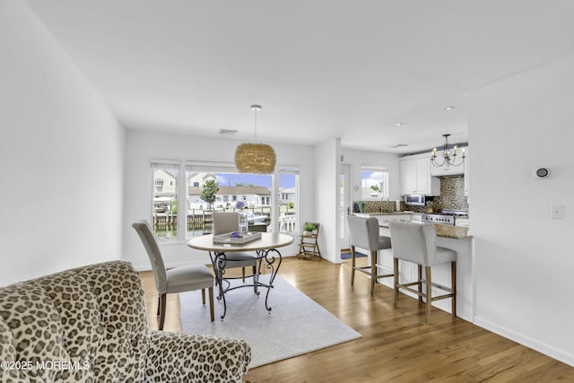813 Tiller Dr, Forked River, NJ 08731 - dining space featuring wood finished floors and a chandelier