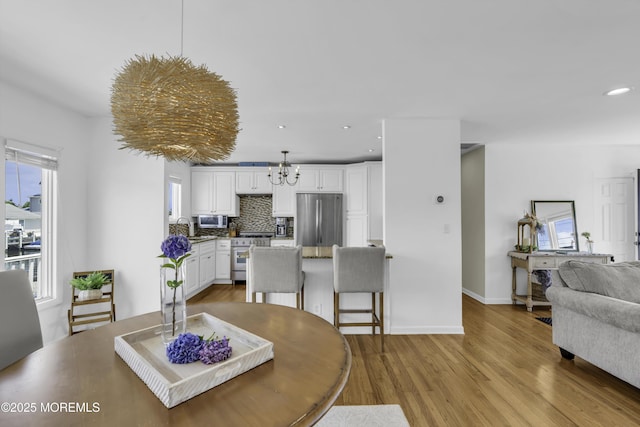 813 Tiller Dr, Forked River, NJ 08731 - dining room featuring wood finished floors, a chandelier, and recessed lighting