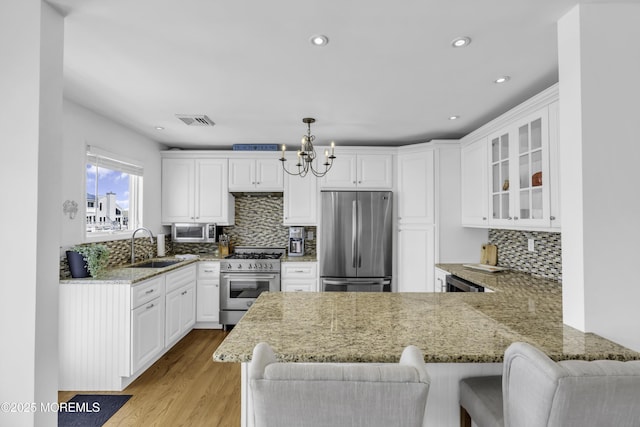 813 Tiller Dr, Forked River, NJ 08731 - kitchen with appliances with stainless steel finishes, a peninsula, white cabinetry, and recessed lighting