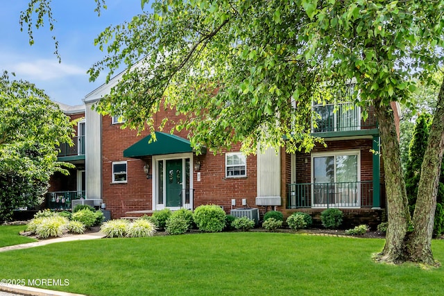 65 Cedar Ave Unit C16, Long Branch, NJ 07740 - view of front facade with brick siding, a front lawn, and a balcony