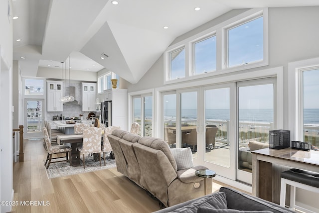 209 E 20th St, Long Beach Twp, NJ 08008 - living room featuring a water view, high vaulted ceiling, and light wood-style floors