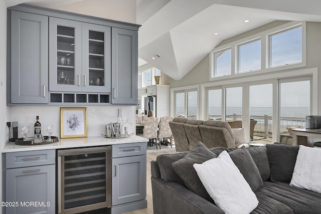 209 E 20th St, Long Beach Twp, NJ 08008 - indoor dry bar with wine cooler, light wood-style floors, high vaulted ceiling, a water view, and recessed lighting