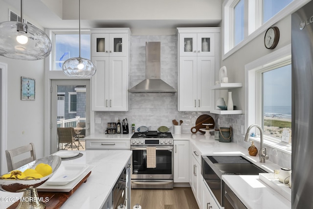 209 E 20th St, Long Beach Twp, NJ 08008 - kitchen with gas range, wall chimney range hood, and white cabinets