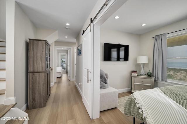 209 E 20th St, Long Beach Twp, NJ 08008 - bedroom featuring a barn door, light wood-style floors, and recessed lighting