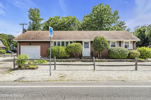 648 E Bayview Ave, Ocean Gate, NJ 08740 - ranch-style home featuring an attached garage, a fenced front yard, driveway, and a shingled roof